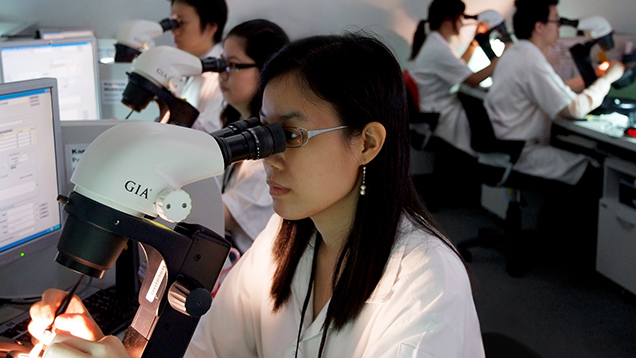 GIA diamond graders looking in microscopes at laboratory in Bangkok GIA diamond graders looking in microscopes at laboratory in Bangkok