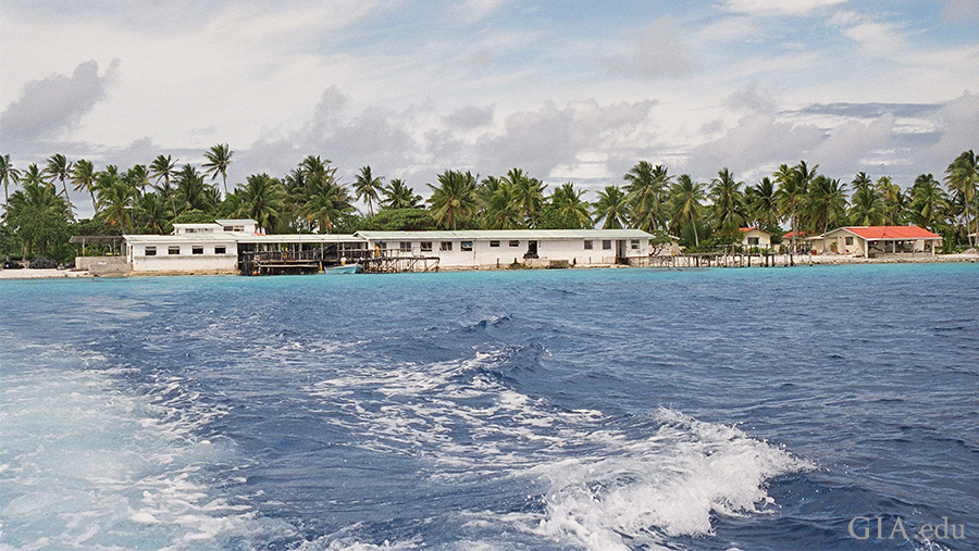 French Polynesia's atolls shield pearl farms from the surrounding ocean waves. Behind the fringe of palm trees, there's a sheltered lagoon that's ideal for mollusk culturing. Photo: Amanda Luke/GIA