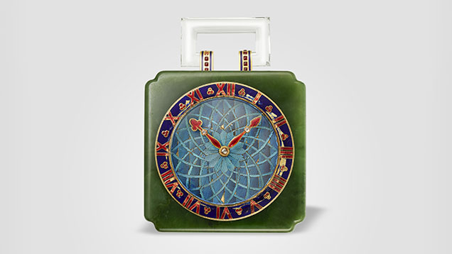 Figure 2. Desk clock, Cartier Paris, 1927, featuring gold, nephrite, Kingfisher feathers (dial), rose-cut diamonds, and red and blue enamel. Courtesy of the Cartier collection. Figure 2. Desk clock, Cartier Paris, 1927, featuring gold, nephrite, Kingfisher feathers (dial), rose-cut diamonds, and red and blue enamel. Courtesy of the Cartier collection.