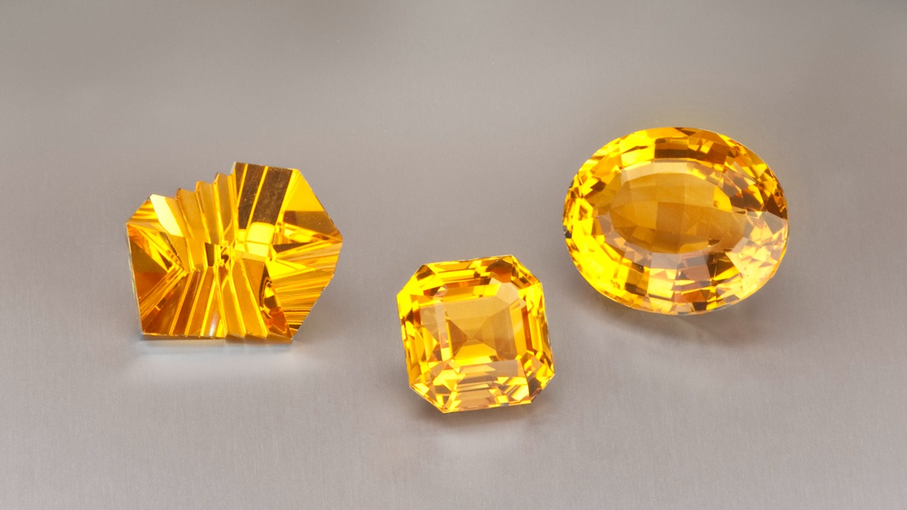 A jeweler’s display shows off citrine’s glowing shades with a designer-cut beauty alongside more traditional emerald-cut and oval gems.