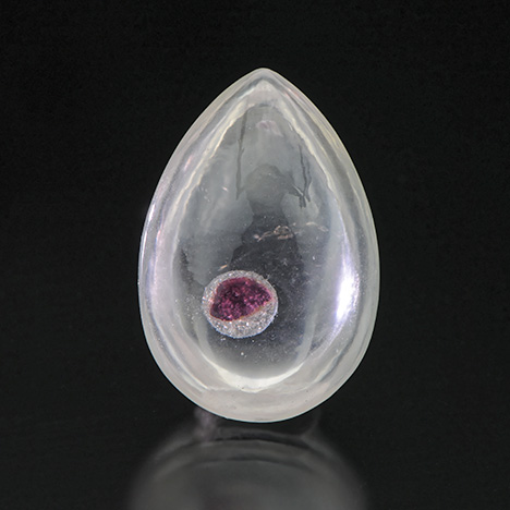 Quartz cabochon with garnet “inclusion” Quartz cabochon with garnet “inclusion”