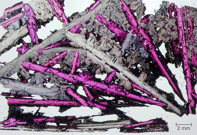A petrographic thin section of ruby-diaoyudaoite slag. A petrographic thin section of ruby-diaoyudaoite slag.