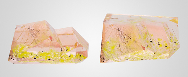Figure 1. Two views of the 2.43 ct orangy pink morganite with bright yellow and dark brown inclusions lying in a plane. Photos by Sandie Clain, © LFG; courtesy of Gravier & Gemmes. Figure 1. Two views of the 2.43 ct orangy pink morganite with bright yellow and dark brown inclusions lying in a plane. Photos by Sandie Clain, © LFG; courtesy of Gravier & Gemmes.