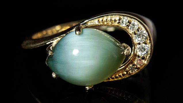 A 3.14 ct marquise cabochon nephrite set in a 14K yellow gold ring. A 3.14 ct marquise cabochon nephrite set in a 14K yellow gold ring.