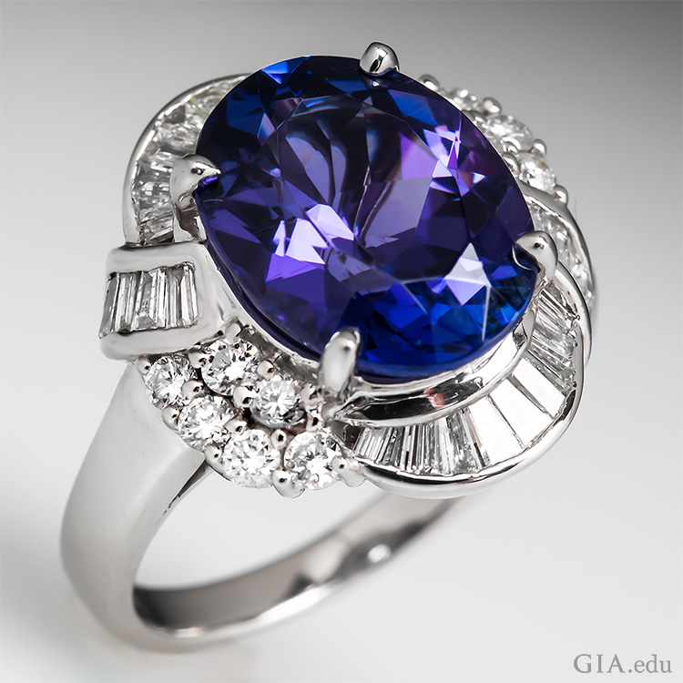  This tanzanite ring boasts the December birthstone with a 5.59 carat oval tanzanite surrounded by 28 tapered baguettes and 12 round brilliant cut diamonds.