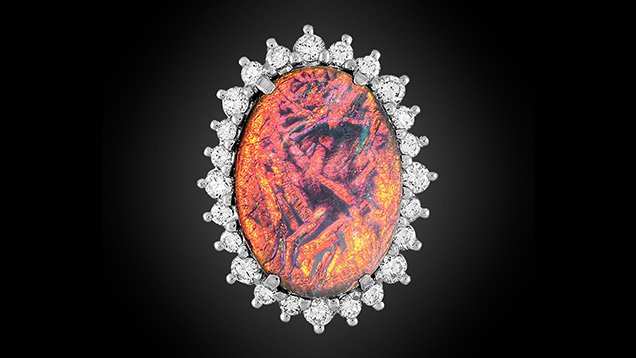 Figure 1. A black opal cabochon displaying orange play-of-color when viewed face-up. Photo by Annie Haynes.