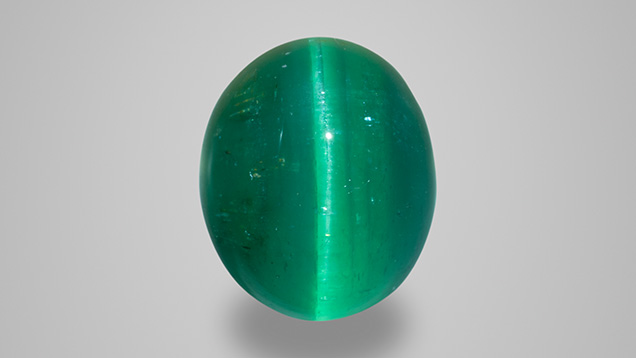 Double cabochon cat’s-eye emerald weighing 5.11 ct and measuring 10.77 × 8.95 × 7.39 mm, from Goiás State, Brazil. Photo by Robert Weldon; courtesy of Douglas M. Liebman Estate Jeweler. Double cabochon cat’s-eye emerald weighing 5.11 ct and measuring 10.77 × 8.95 × 7.39 mm, from Goiás State, Brazil. Photo by Robert Weldon; courtesy of Douglas M. Liebman Estate Jeweler.