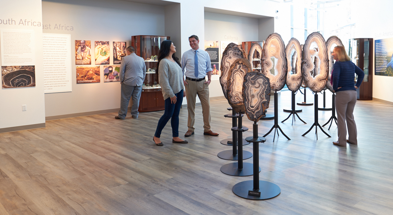 Guests at GIA exhibit looking at full Eyes of Brazil exhibit