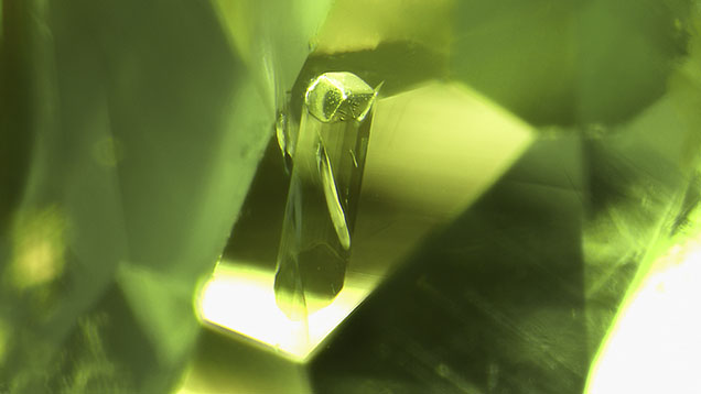 A euhedral tourmaline crystal in a tourmaline host. Photomicrograph by Hikaru Sato; field of view 1.95 mm. A euhedral tourmaline crystal in a tourmaline host. Photomicrograph by Hikaru Sato; field of view 1.95 mm.