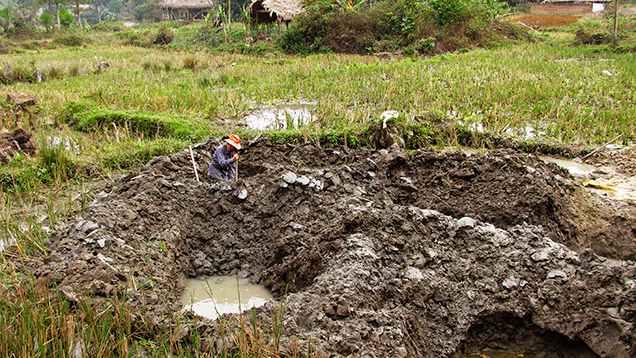 Farmer digging for tourmaline in Luc Yen, Vietnam Farmer digging for tourmaline in Luc Yen, Vietnam