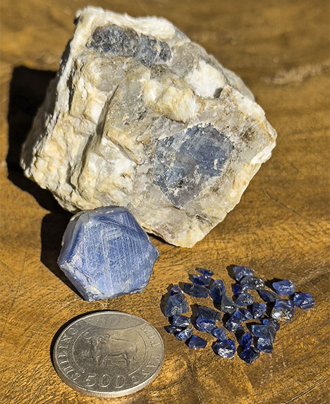 Figure 1. Blue sapphires from the Matepwende area in southern Tanzania. Most of the production consists of low-clarity material in matrix. Only a very small percentage (usually weighing less than 1 ct) is clean enough to be faceted. Photo by Vincent Pardieu.