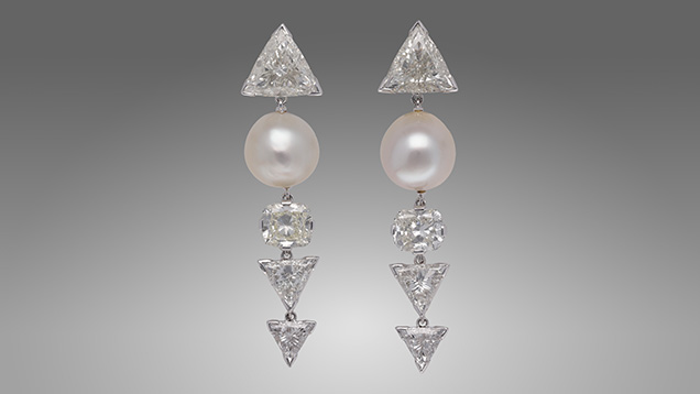 Figure 1. Two partially drilled button-shaped light cream assembled pearls weighing 7.40 and 9.37 ct, respectively, mounted in a pair of earrings. Photo by Gaurav Bera. Figure 1. Two partially drilled button-shaped light cream assembled pearls weighing 7.40 and 9.37 ct, respectively, mounted in a pair of earrings. Photo by Gaurav Bera.