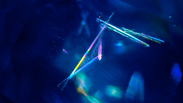 Prismatic elongated zircon in Kashmir sapphire. Photomicrograph by Narint Jaisanit; field of view 2.88 mm. Prismatic elongated zircon in Kashmir sapphire. Photomicrograph by Narint Jaisanit; field of view 2.88 mm.
