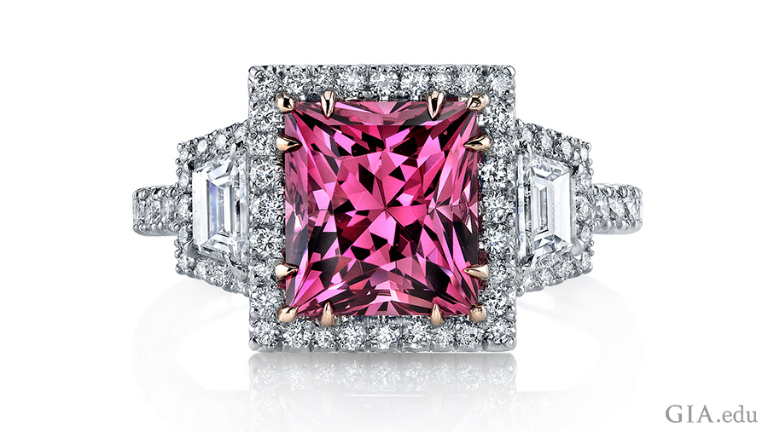 The August birthstone is featured in a 3.55 carat princess cut pink spinel ring surrounded by round brilliant diamonds and two trapezoid diamonds. The August birthstone is featured in a 3.55 carat princess cut pink spinel ring surrounded by round brilliant diamonds and two trapezoid diamonds.