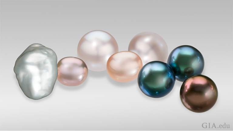 Today, cultured pearls can be found in a wide variety of shapes, colors and sizes (here, measuring between 9 mm and 23 mm). From left to right: a baroque cultured pearl; small fancy pink and peach off-round freshwater cultured pearls; round white Australian cultured pearls; and black and brown Tahitian cultured pearls. Photo: Robert Weldon/GIA.