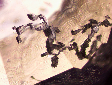 Partially dissolved fluorite relics in interconnected cavities.