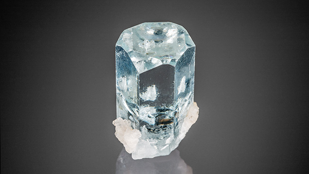 Hexagonal growth hillocks decorate the termination of this Pakistani aquamarine.
