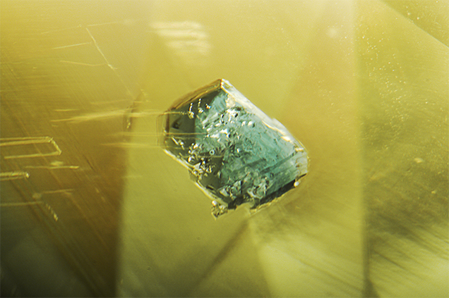 Bluish green spinel in Sri Lankan yellow sapphire.