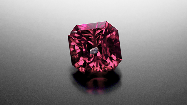 Pyrope-spessartine garnet with an unusual blue apatite inclusion.