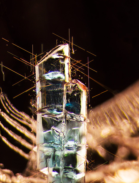 Needles surround blue apatite crystals in a Tanzanian garnet.