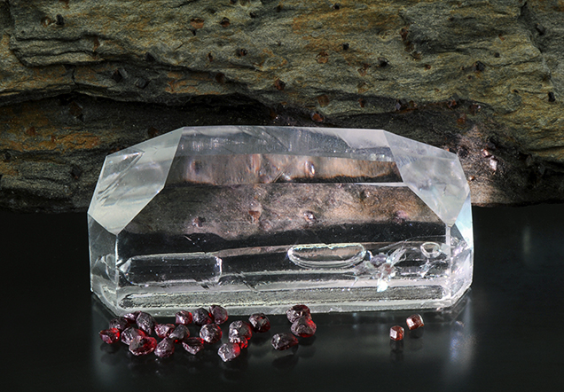 Synthetic quartz crystal with inclusion suite of almandine and pyrope.