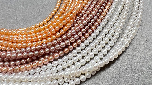 Figure 1. Near-round to round small freshwater bead cultured pearls (approximately 2–4 mm) were widely available at the AGTA show in various colors including white, pink, purple, and orange. Photo by Artitaya Homkrajae; courtesy of Betty Sue King, King’s Ransom.