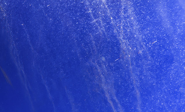 Exsolution silk seen amid particle stringers in a Kashmir star sapphire.
