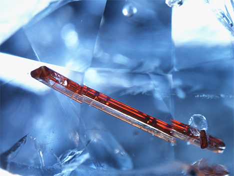 Elongated orange rutile crystal in a sapphire from Afghanistan.