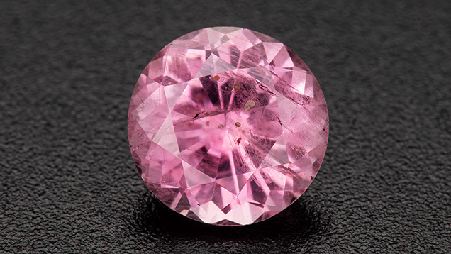 Figure 1. A 1.28 ct heated pink round brilliant sapphire. Photo by Robert Weldon; courtesy of Greenland Ruby.
