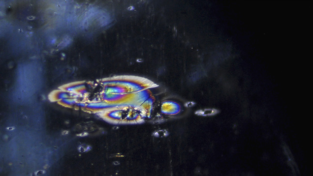 Zircon crystals associated with stress cracks in kyanite
