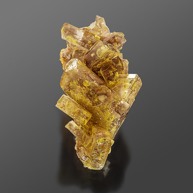 Bright yellow inclusions inside barite crystals.
