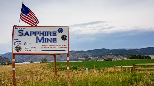 Spokane Sapphire Mine sign and flag in field