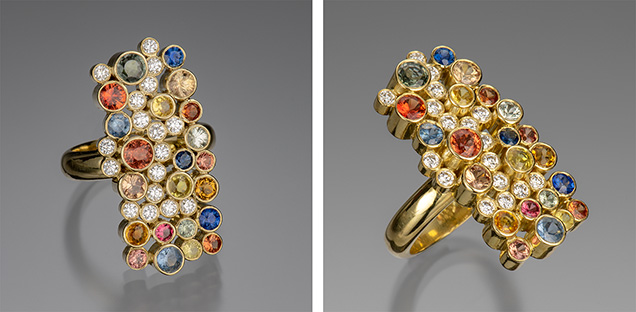Figure 1. The “Seven Sisters” ring in 18K gold with 17 bezel-set diamonds (0.55 carats total) and 22 sapphires ranging in size from 2.5 to 4.0 mm in blue, orange, mandarin, pink, and green (3.15 carats total). Photo by Robert Weldon; courtesy of Sean Hill Designs.