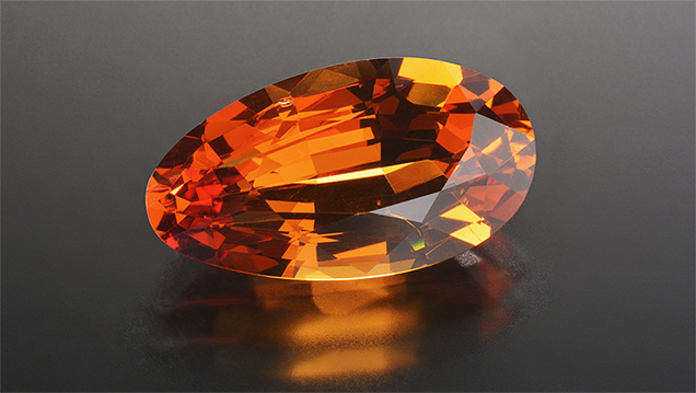 Orange pear-shaped pyrope-spessartine-grossular garnet.
