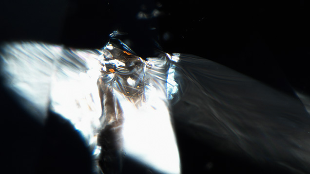 Brownish orange hematite crystals concentrate along a fracture in diamond.