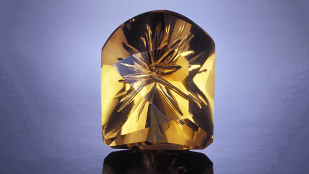 Low-temperature heat treatment transformed an amethyst into this orangy citrine. A gem carver created the attractive fantasy cut. - GIA & Tino Hammid Low-temperature heat treatment transformed an amethyst into this orangy citrine. A gem carver created the attractive fantasy cut. - GIA & Tino Hammid