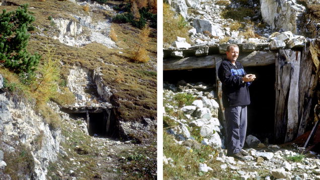 A hillside with a rocky entrance to a mine on the left; on the right, a person stands outside the mine holding an object.