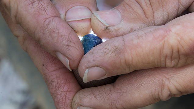 Hands holding sapphire Hands holding sapphire