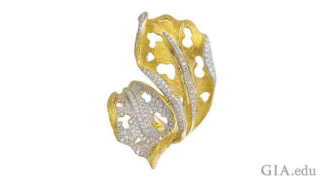 Photograph of gold ring shaped like a leaf with many melee stones set in various areas.