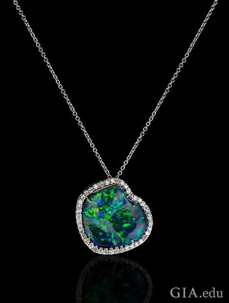 A 20.80 ct black opal set in 18kt white gold, accented with 1.26 cts of diamonds. A 20.80 ct black opal set in 18kt white gold, accented with 1.26 cts of diamonds.