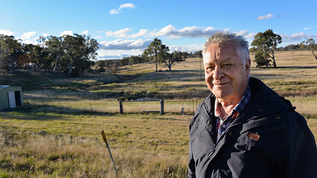 Man in front of old sapphire mining site
