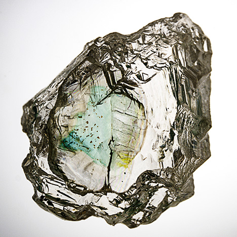 Rough diamond with green coloration along internal cleavage. Rough diamond with green coloration along internal cleavage.
