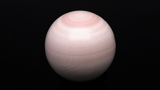 Figure 1. This round light pink bead fashioned Queen conch shell (10.20 mm and 7.50 ct) resembled a Queen conch pearl. Photo by Gaurav Bera. Figure 1. This round light pink bead fashioned Queen conch shell (10.20 mm and 7.50 ct) resembled a Queen conch pearl. Photo by Gaurav Bera.
