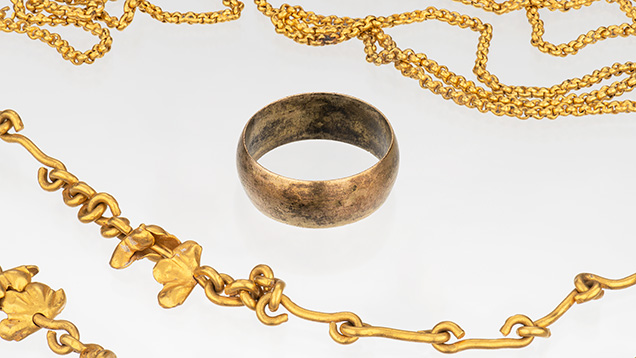 Figure 6. Two gold chains and a plain gold ring from the 1715 shipwreck. Photo by Emily Lane.