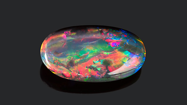 Black opal cabochon from Lightning Ridge.