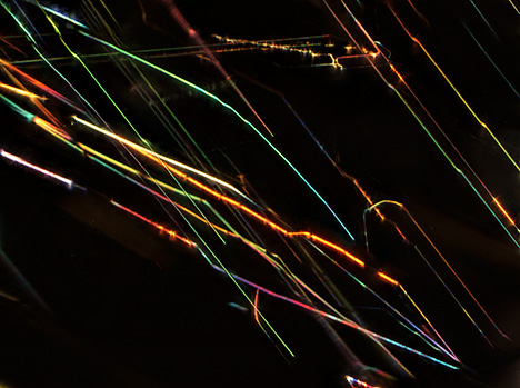 Thin-film iridescence of musgravite viewed using oblique fiber-optic illumination. Thin-film iridescence of musgravite viewed using oblique fiber-optic illumination.
