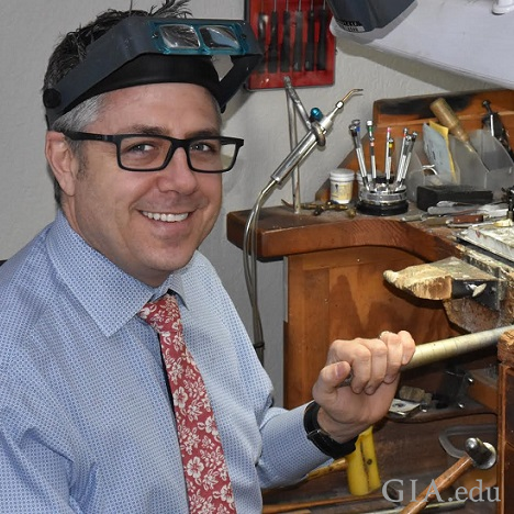 Man at a jeweler’s bench.