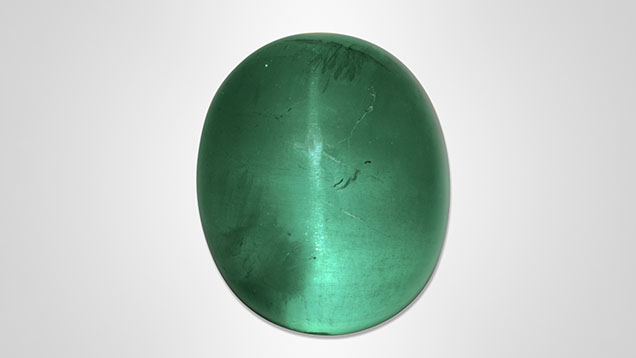 Figure 1. An unusually large cat’s-eye emerald weighing approximately 126 ct. Photo by Shunsuke Nagai.