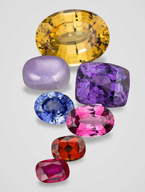 Figure 3. Alluvial gems that can more commonly be found in sediments. From left to right and top to bottom: 16.94 ct grossular, Tanzania; 9.72 ct jadeite, Myanmar; 13.52 ct spinel, Sri Lanka; 4.86 ct sapphire, Myanmar; 4.43 ct rhodolite, Tanzania; 2.53 ct rhodolite, Tanzania; and 2.21 ct ruby, Myanmar. Composite image by Robert Weldon.