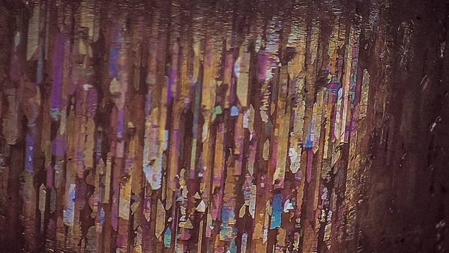 A photomicrograph shows inclusions in a gem from Oregon’s Ponderosa Mine, magnified 12 times